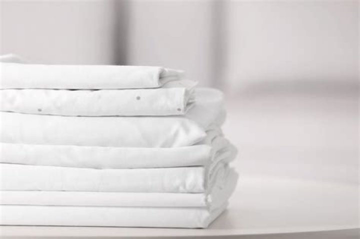 Should i wash crib sheets before use?