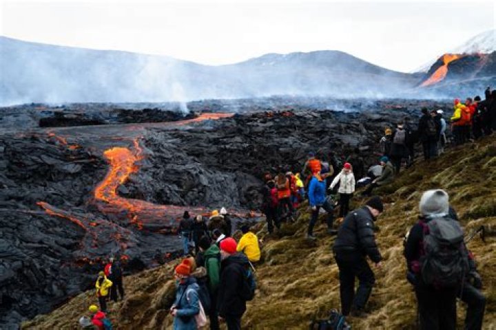 Why do volcanoes attract tourists?